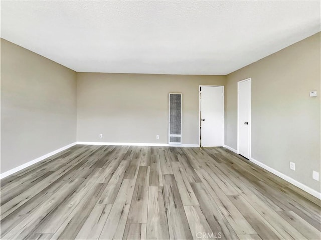 1920 N H St Unit 251, Oxnard, CA 93036 - spare room featuring a heating unit and wood finished floors