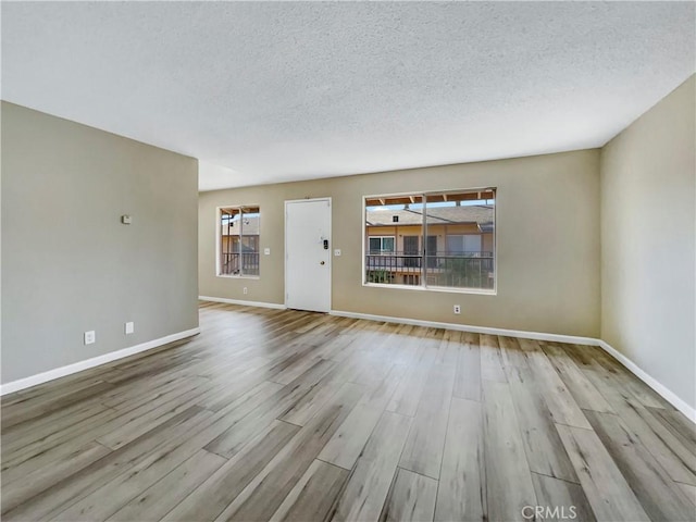 1920 N H St Unit 251, Oxnard, CA 93036 - unfurnished living room featuring wood finished floors and a textured ceiling