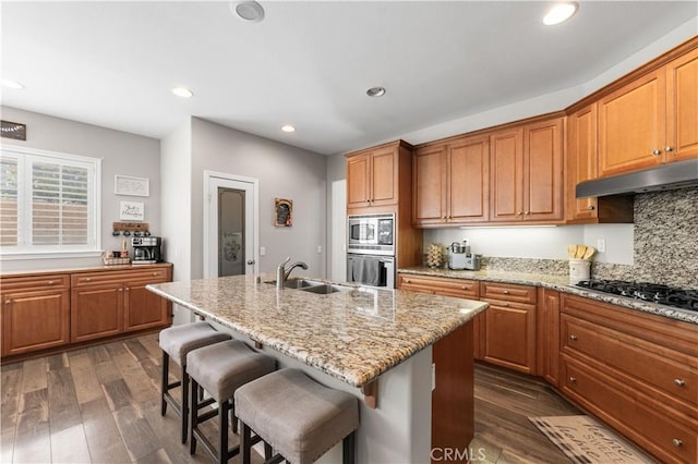 42639 Biscay, Lancaster, CA 93536 - kitchen with stainless steel appliances, dark wood finished floors, a kitchen bar, under cabinet range hood, and recessed lighting