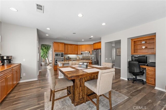 42639 Biscay, Lancaster, CA 93536 - dining area featuring dark wood-style floors, recessed lighting, and built in desk