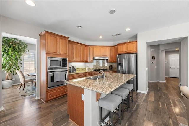 42639 Biscay, Lancaster, CA 93536 - kitchen with stainless steel appliances, under cabinet range hood, a center island with sink, dark wood-style floors, and recessed lighting