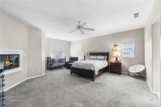 42639 Biscay, Lancaster, CA 93536 - bedroom with carpet, multiple windows, a ceiling fan, and a glass covered fireplace