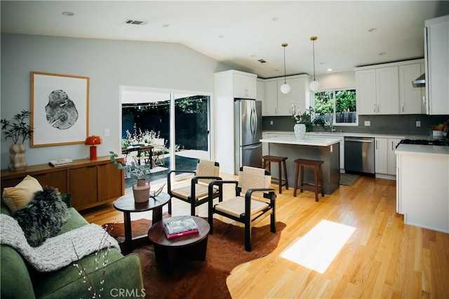17442 Burma St, Encino, CA 91316 - living room featuring light wood finished floors, vaulted ceiling, and recessed lighting