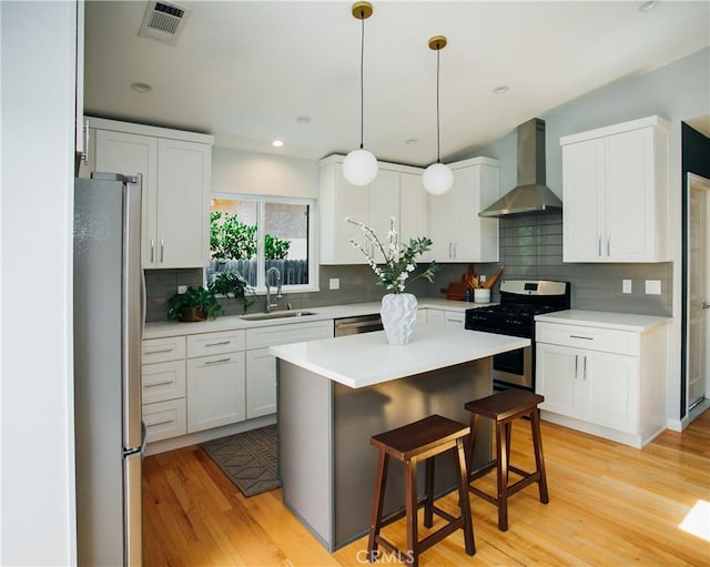 17442 Burma St, Encino, CA 91316 - kitchen with wall chimney exhaust hood, stainless steel appliances, backsplash, light countertops, and recessed lighting