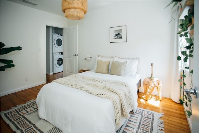 17442 Burma St, Encino, CA 91316 - bedroom with stacked washer / dryer and wood finished floors
