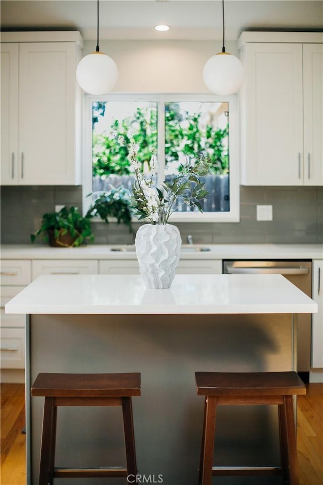 17442 Burma St, Encino, CA 91316 - kitchen with backsplash, a kitchen breakfast bar, white cabinetry, light countertops, and recessed lighting