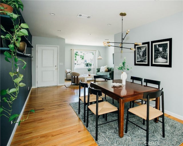 17442 Burma St, Encino, CA 91316 - dining space with a chandelier and light wood-type flooring