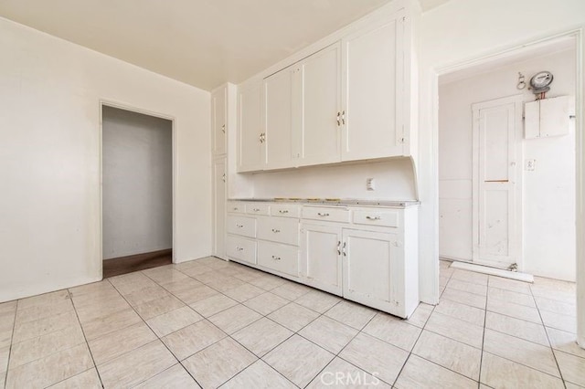 329 N Bushnell Ave, Alhambra, CA 91801 - kitchen featuring white cabinetry, light tile patterned floors, and light countertops