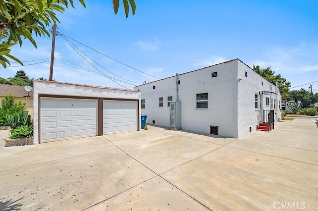 329 N Bushnell Ave, Alhambra, CA 91801 - view of home's exterior featuring a detached garage, stucco siding, and an outdoor structure