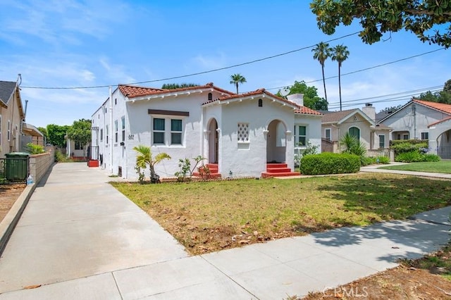 329 N Bushnell Ave, Alhambra, CA 91801 - mediterranean / spanish home featuring stucco siding, a front lawn, and driveway