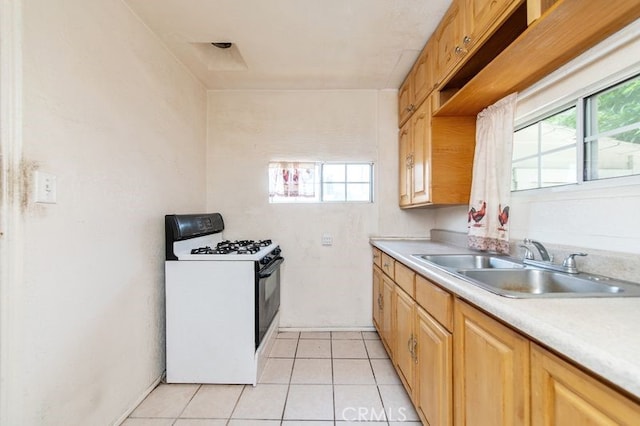 329 N Bushnell Ave, Alhambra, CA 91801 - kitchen with white gas stove, light countertops, healthy amount of natural light, and light tile patterned floors