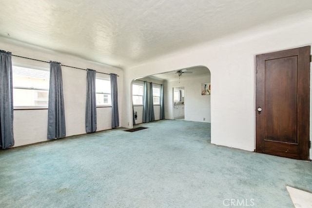329 N Bushnell Ave, Alhambra, CA 91801 - unfurnished room with arched walkways, carpet floors, and a textured ceiling
