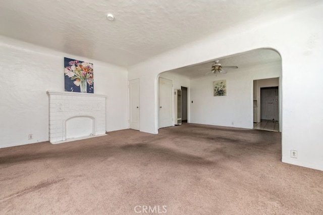 329 N Bushnell Ave, Alhambra, CA 91801 - unfurnished living room with carpet floors, ceiling fan, a textured ceiling, and a fireplace