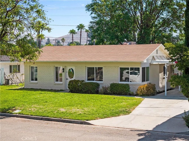 3024 Carl St, Riverside, CA 92507 - ranch-style home with a front yard, concrete driveway, roof with shingles, and brick siding