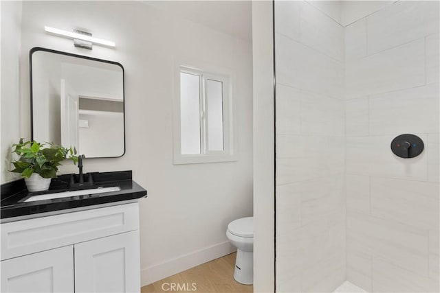 3024 Carl St, Riverside, CA 92507 - bathroom with tiled shower, vanity, and wood finished floors