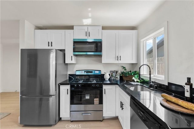 3024 Carl St, Riverside, CA 92507 - kitchen with appliances with stainless steel finishes, white cabinets, and light wood finished floors