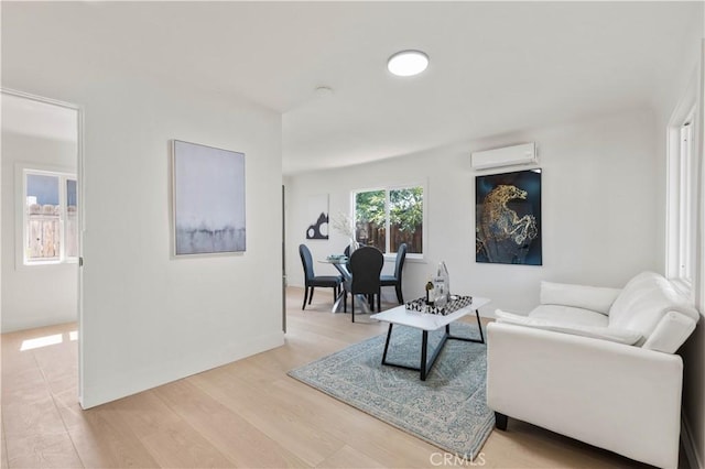 3024 Carl St, Riverside, CA 92507 - living room with a wall unit AC and light wood-style floors