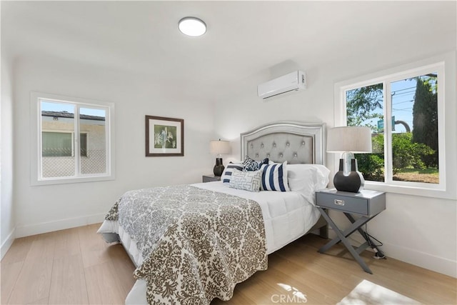 3024 Carl St, Riverside, CA 92507 - bedroom featuring a wall mounted air conditioner and wood finished floors