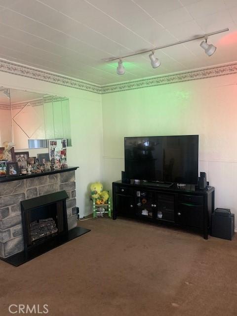 524 E Main St, San Gabriel, CA 91776 - living room with rail lighting, carpet flooring, and a stone fireplace