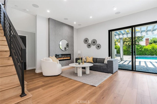 251 S Griffith Park Dr, Burbank, CA 91506 - living area with stairs, light wood-style floors, a large fireplace, and recessed lighting