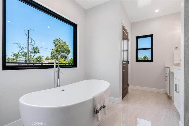 251 S Griffith Park Dr, Burbank, CA 91506 - full bathroom featuring vanity, a freestanding tub, marble look tile flooring, and recessed lighting