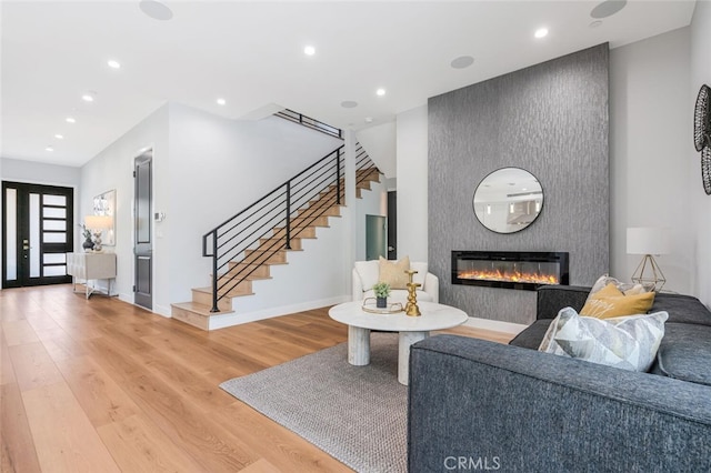 251 S Griffith Park Dr, Burbank, CA 91506 - living room featuring stairs, light wood-style flooring, a fireplace, and recessed lighting