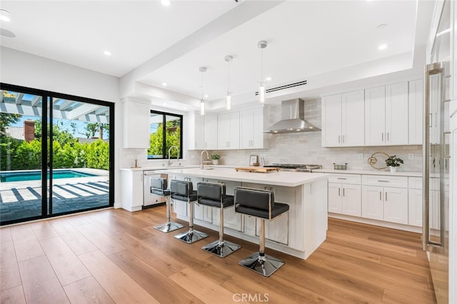 251 S Griffith Park Dr, Burbank, CA 91506 - kitchen featuring wall chimney exhaust hood, dishwashing machine, light countertops, light wood-style floors, and recessed lighting