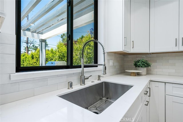 251 S Griffith Park Dr, Burbank, CA 91506 - kitchen with healthy amount of natural light, tasteful backsplash, light stone countertops, and white cabinets