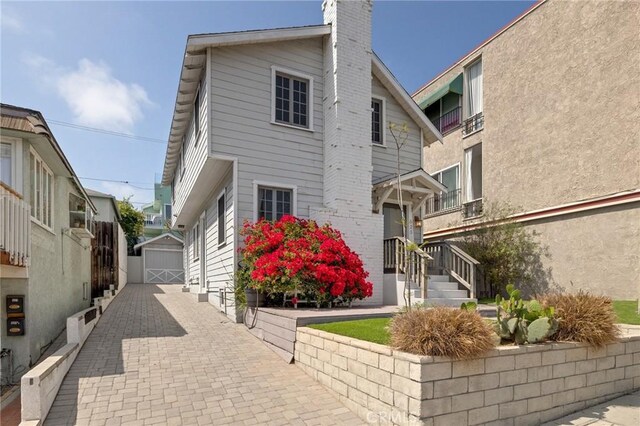 525 Manhattan Beach Blvd, Manhattan Beach, CA 90266 - view of front facade with a chimney and a garage