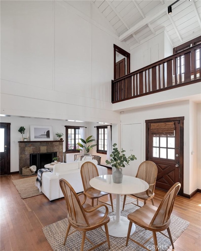 525 Manhattan Beach Blvd, Manhattan Beach, CA 90266 - dining area with high vaulted ceiling, light wood-style flooring, a fireplace, and a wood ceiling with exposed beams