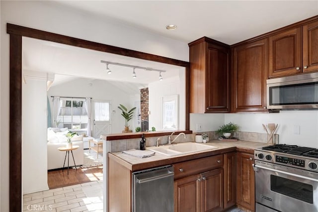 525 Manhattan Beach Blvd, Manhattan Beach, CA 90266 - kitchen with stainless steel appliances, a peninsula, open floor plan, tile countertops, and track lighting