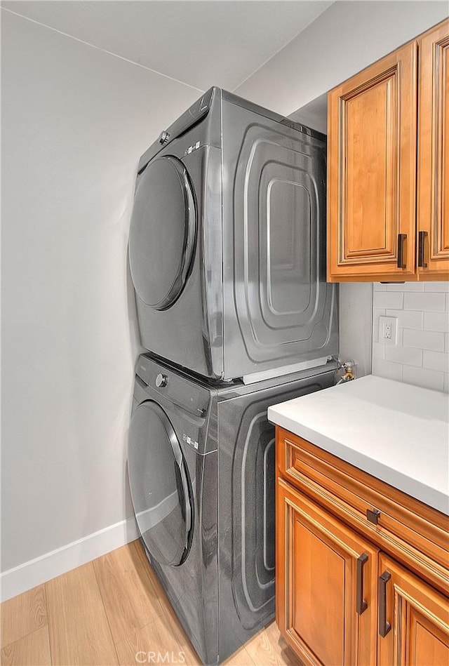 3096 Panorama Rd Unit A, Riverside, CA 92506 - laundry room with cabinet space, estacked washer and dryer, and light wood finished floors