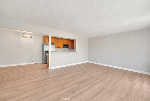3096 Panorama Rd Unit A, Riverside, CA 92506 - unfurnished living room featuring a textured ceiling and light wood-style floors