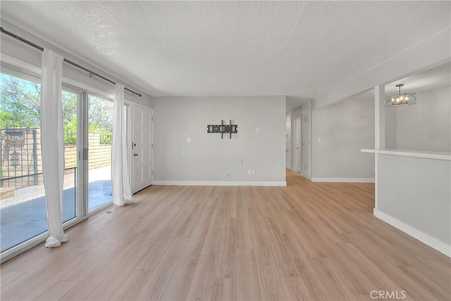 3096 Panorama Rd Unit A, Riverside, CA 92506 - unfurnished living room with a textured ceiling and light wood-style floors