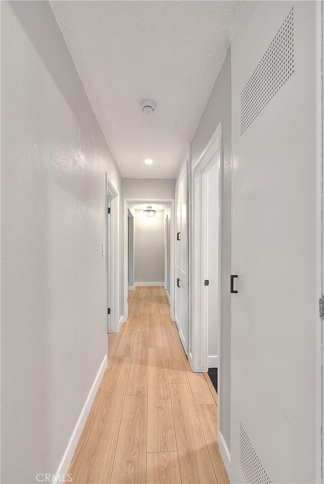 3096 Panorama Rd Unit A, Riverside, CA 92506 - corridor with light wood-style floors and a textured ceiling