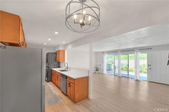 3096 Panorama Rd Unit A, Riverside, CA 92506 - kitchen featuring freestanding refrigerator, dishwasher, brown cabinets, open floor plan, and light countertops