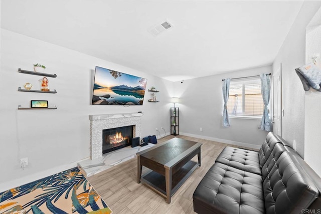 353 61st St, San Diego, CA 92114 - living room featuring a glass covered fireplace and wood finished floors