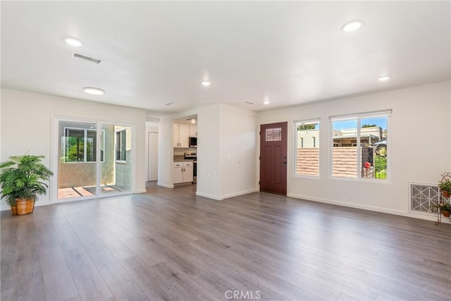 3066 Via Serena S Unit A, Laguna Woods, CA 92637 - unfurnished living room featuring healthy amount of natural light, dark wood-style floors, and recessed lighting