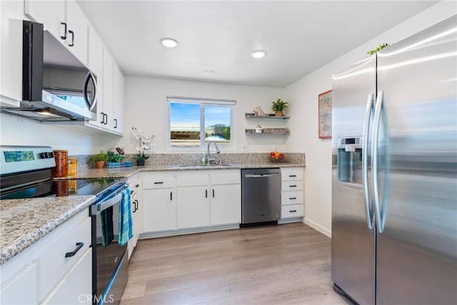 3066 Via Serena S Unit A, Laguna Woods, CA 92637 - kitchen with stainless steel appliances, light wood finished floors, recessed lighting, white cabinetry, and light stone countertops