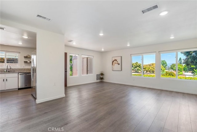 3066 Via Serena S Unit A, Laguna Woods, CA 92637 - unfurnished living room featuring healthy amount of natural light, dark wood-type flooring, and recessed lighting