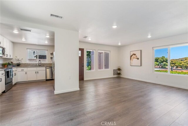 3066 Via Serena S Unit A, Laguna Woods, CA 92637 - unfurnished living room with dark wood-style floors and recessed lighting