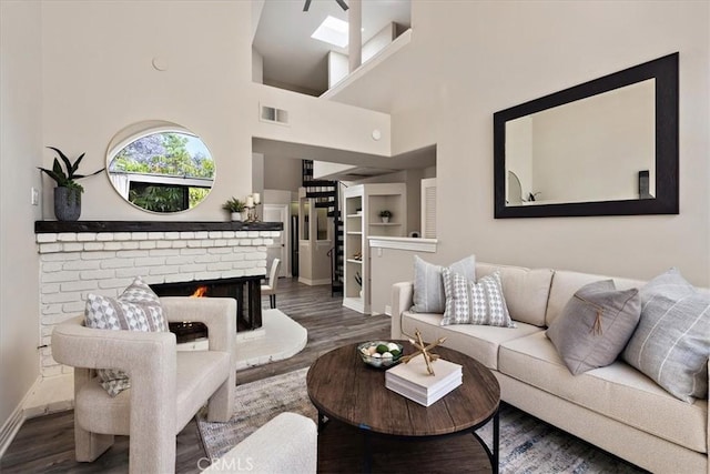 17202 Corbina Ln Unit 208, Huntington Beach, CA 92649 - living area with wood finished floors, a brick fireplace, and stairway