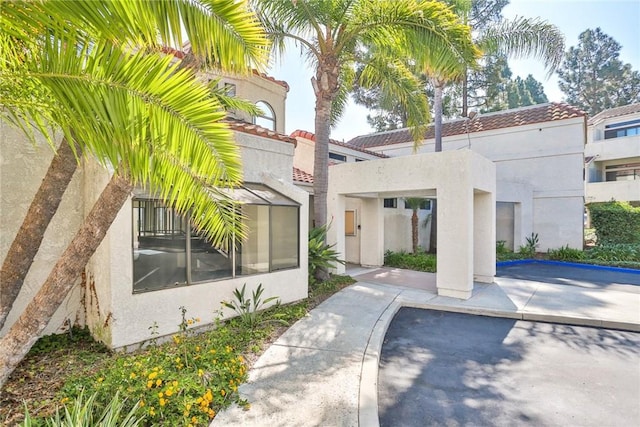 17202 Corbina Ln Unit 208, Huntington Beach, CA 92649 - view of front facade with stucco siding and a tiled roof