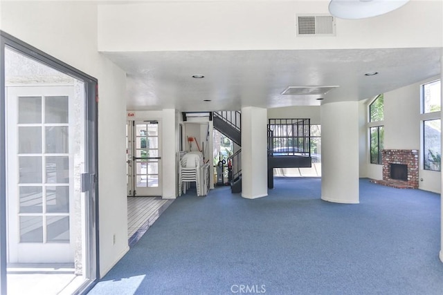 17202 Corbina Ln Unit 208, Huntington Beach, CA 92649 - interior space featuring carpet flooring, plenty of natural light, stairs, and a brick fireplace