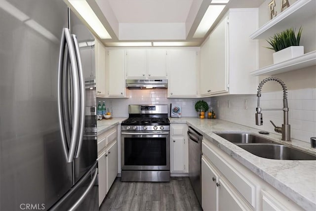 17202 Corbina Ln Unit 208, Huntington Beach, CA 92649 - kitchen with stainless steel appliances, open shelves, under cabinet range hood, dark wood-style flooring, and white cabinetry