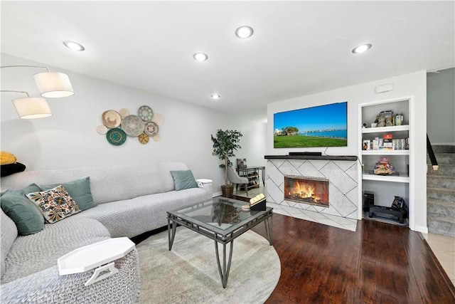 1465 E Lexington Ave Unit 4C, El Cajon, CA 92019 - living area with wood-type flooring, a tiled fireplace, recessed lighting, and built in features