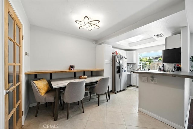 1465 E Lexington Ave Unit 4C, El Cajon, CA 92019 - dining space with light tile patterned floors and a tray ceiling