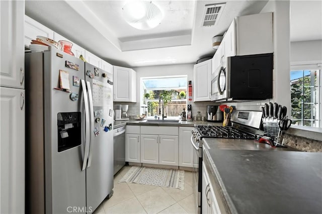 1465 E Lexington Ave Unit 4C, El Cajon, CA 92019 - kitchen with stainless steel appliances, healthy amount of natural light, tasteful backsplash, and a raised ceiling