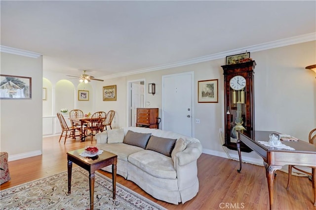 2205 Via Mariposa E Unit A, Laguna Woods, CA 92637 - living room featuring light wood finished floors, crown molding, ceiling fan, and arched walkways