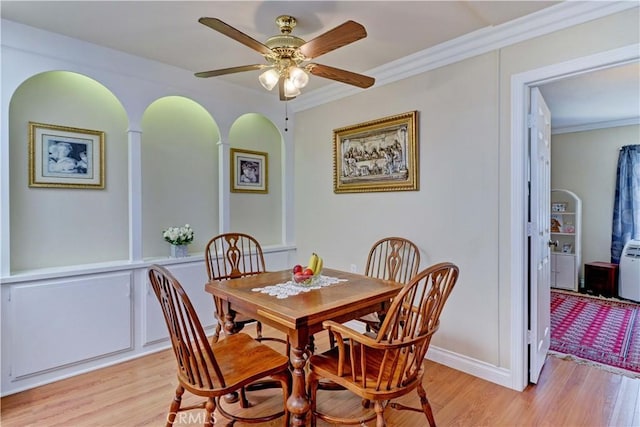 2205 Via Mariposa E Unit A, Laguna Woods, CA 92637 - dining space with light wood finished floors, ceiling fan, crown molding, and arched walkways